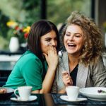 portrait-two-girl-friends-spend-time-together-drinking-coffee-cafe-having-fun-by-eating-dessert-cakes-said-secret-other-hapiness_496169-2102