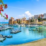 Sicily Italy landscape with water and homes in background